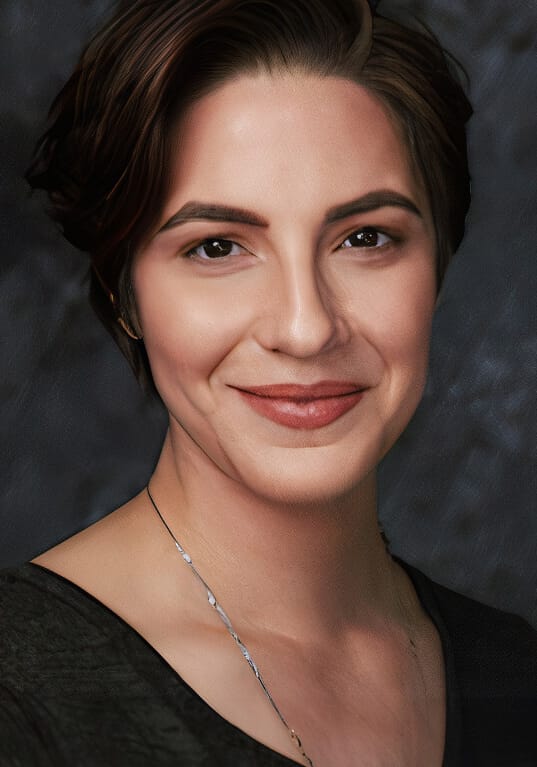 Headshot of Heather La Kor, a woman with short, dark brown hair styled neatly, wearing a subtle smile. The individual has light skin, well-defined eyebrows, and a natural makeup look, with soft lipstick and minimal accessories, aside from a delicate necklace. The background is a dark, textured gradient, providing contrast and making the subject stand out. The expression is calm and friendly.